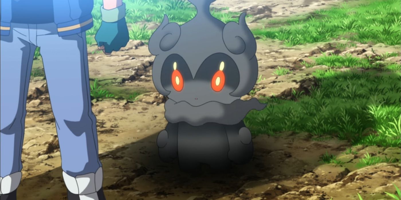 Marshadow the Ghost/Fighting Pokemon floating next to Ash. 