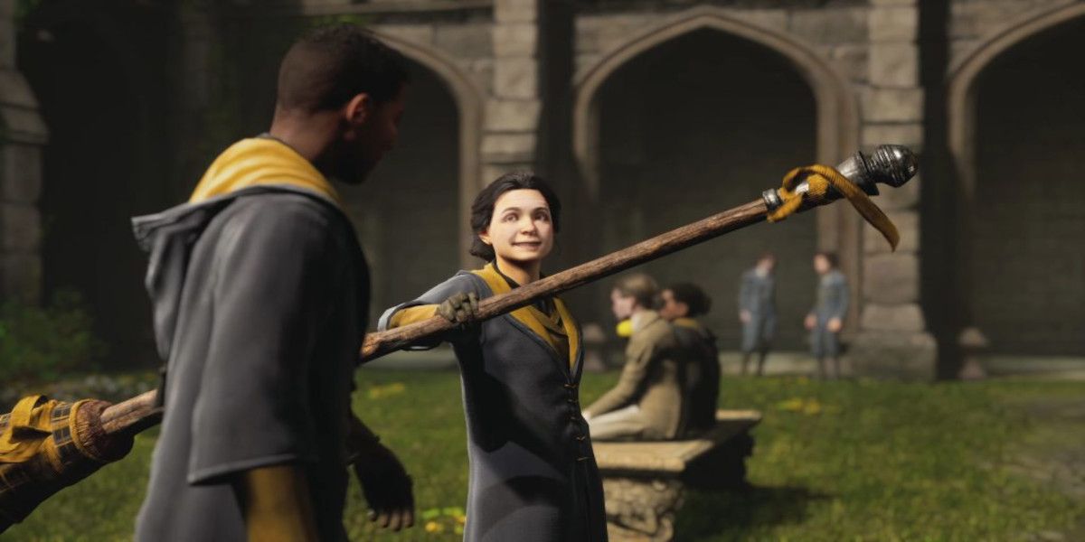 A student takes a broom in the trailer for Hogwarts Legacy