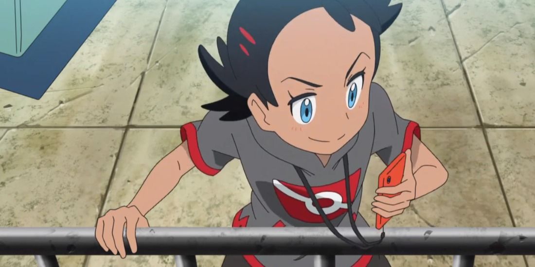 New protagonist Goh looking at his phone from the Pokemon anime