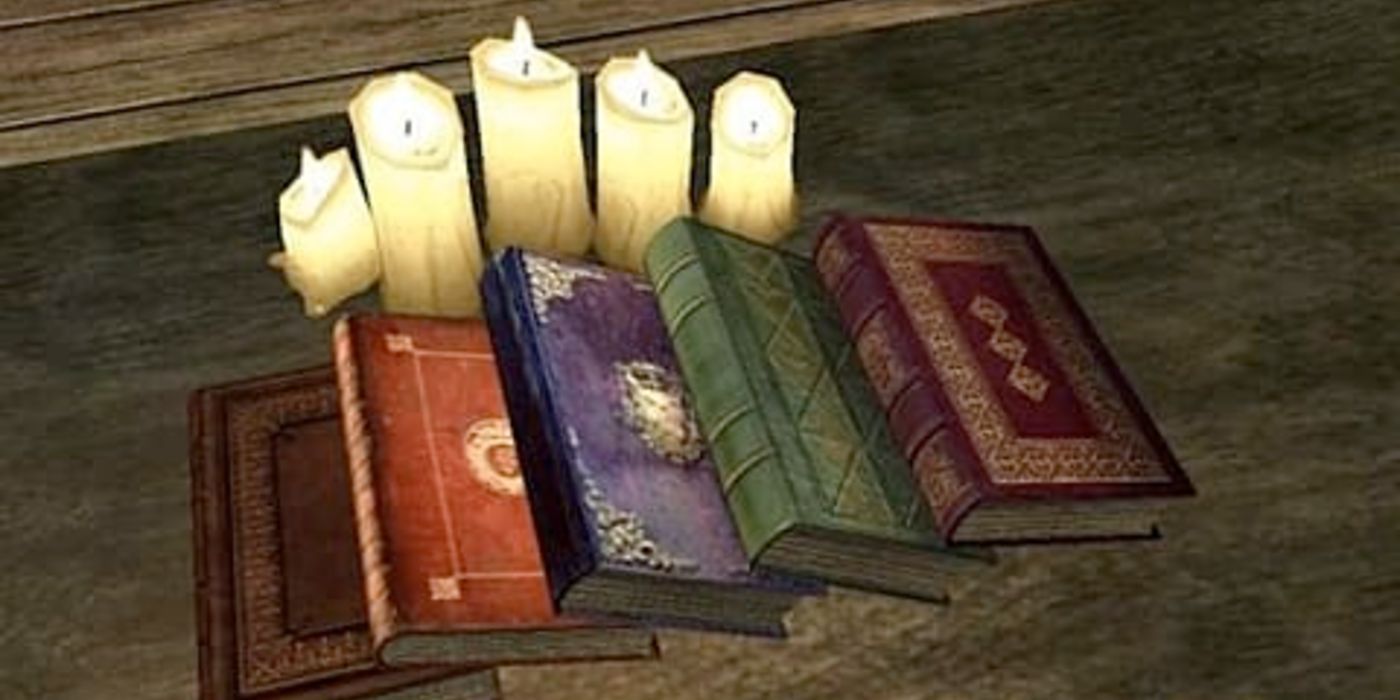 A set of books are laid out on a table, next to some candles.