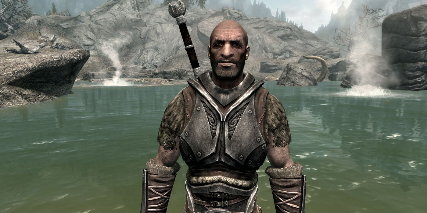 A bald man in metal and fur armor stands at a hot springs, looking unimpressed.