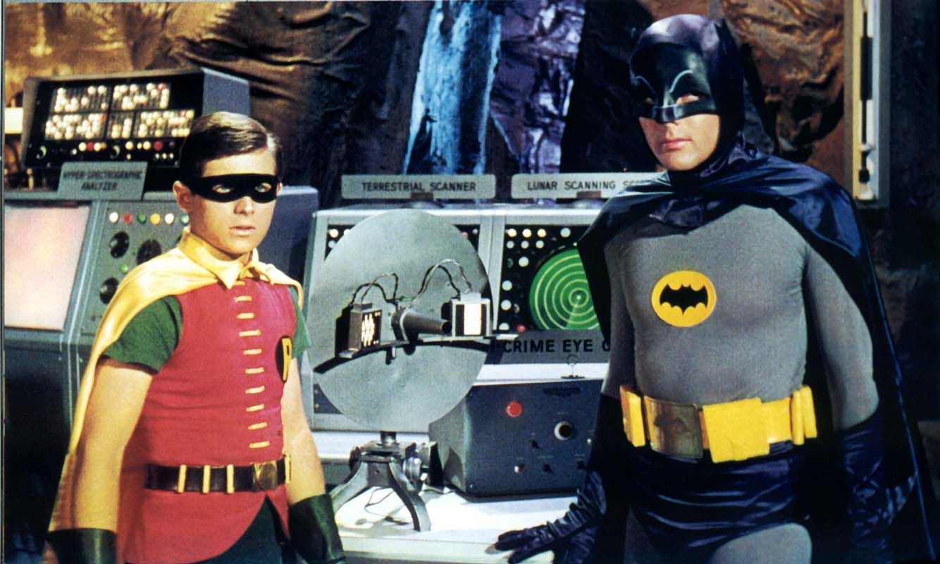 Batman and robin standing next to dish