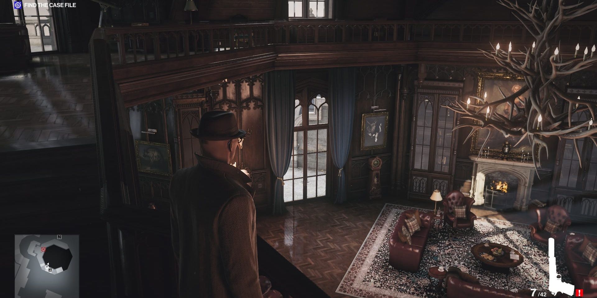Agent 47 at the top of the Carlisle mansion stairs as he stares at the moose antler chandelier in the main hall