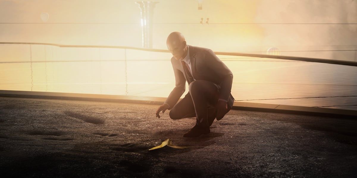 Agent 47 kneeling over a banana peel on the ground