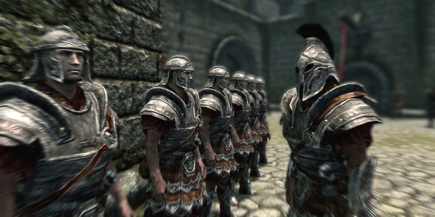 A row of men armored in metal form up to be inspected by a commander.