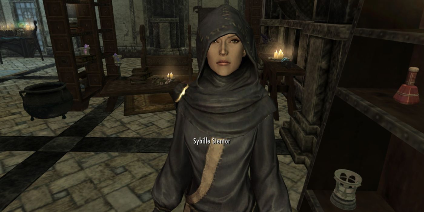 A screenshot of a woman dressed in blue mage's robes inside her room.
