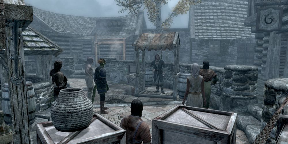 A gameplay screenshot of Skyrim's Riften, featuring Brynjolf speaking to a crowd.