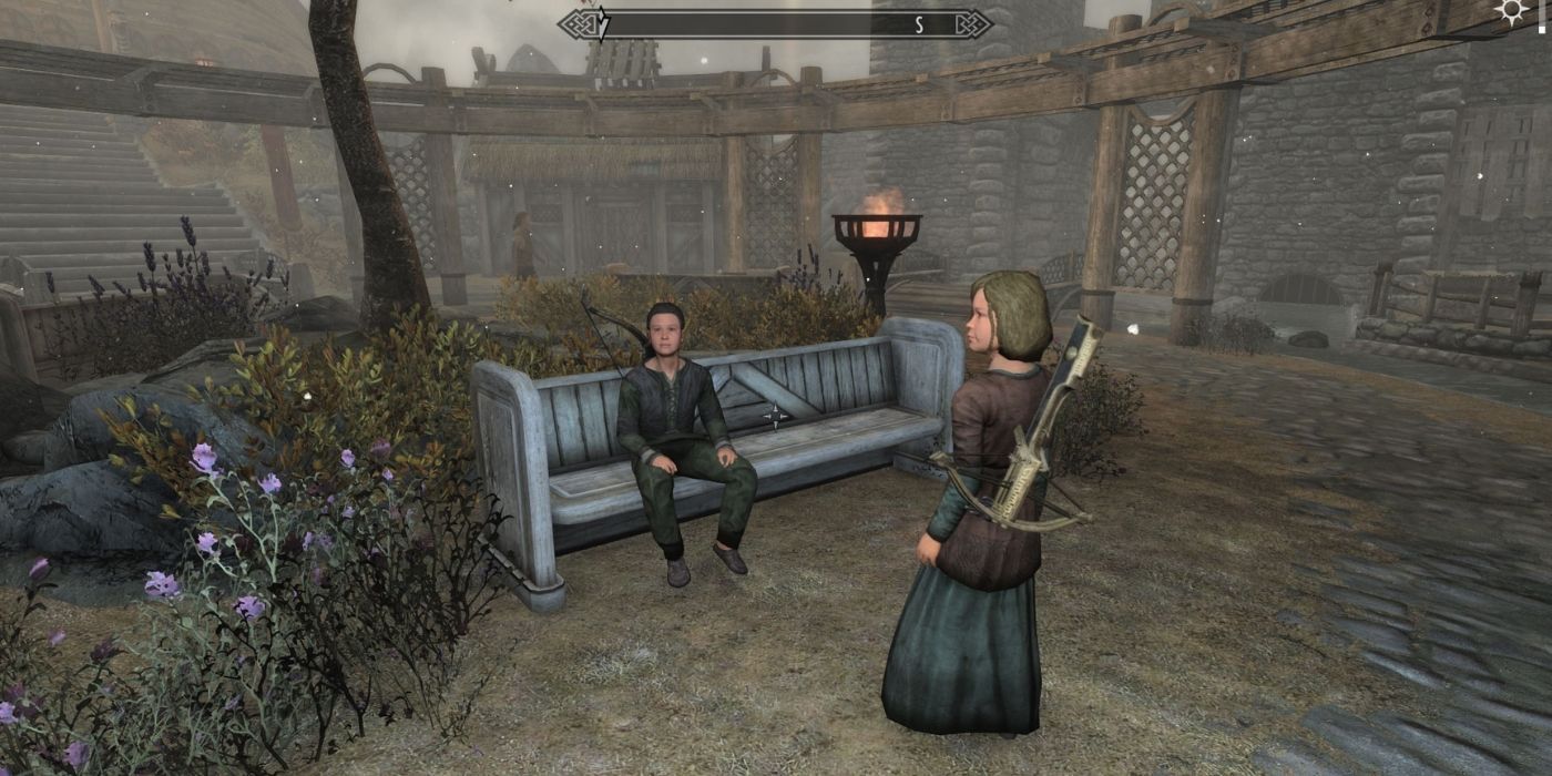 Skyrim - image of two children sitting together in Whiterun with weapons equipped from the More Gifts For Children mod