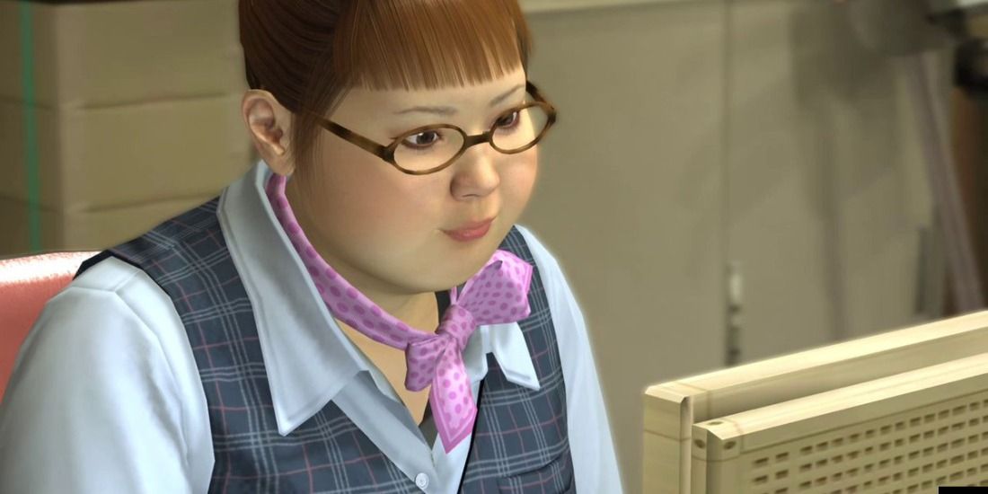 Hana from Yakuza 4 doing work at her computer with her pink scarf
