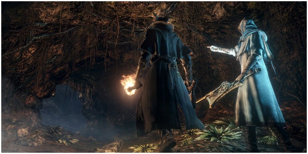 Two players entering a cave together in Bloodborne for some jolly cooperation