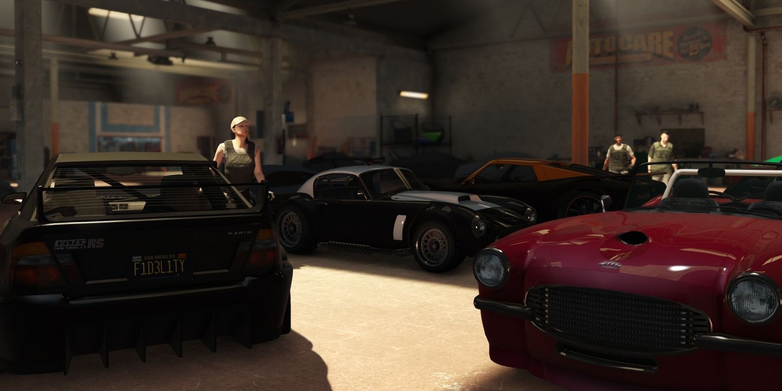 Some people taking care of the luxurious cars inside the warehouse.