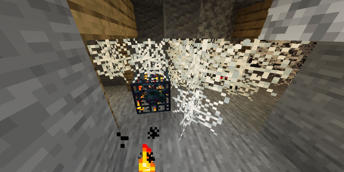 Minecraft cobwebs next to a spider spawner