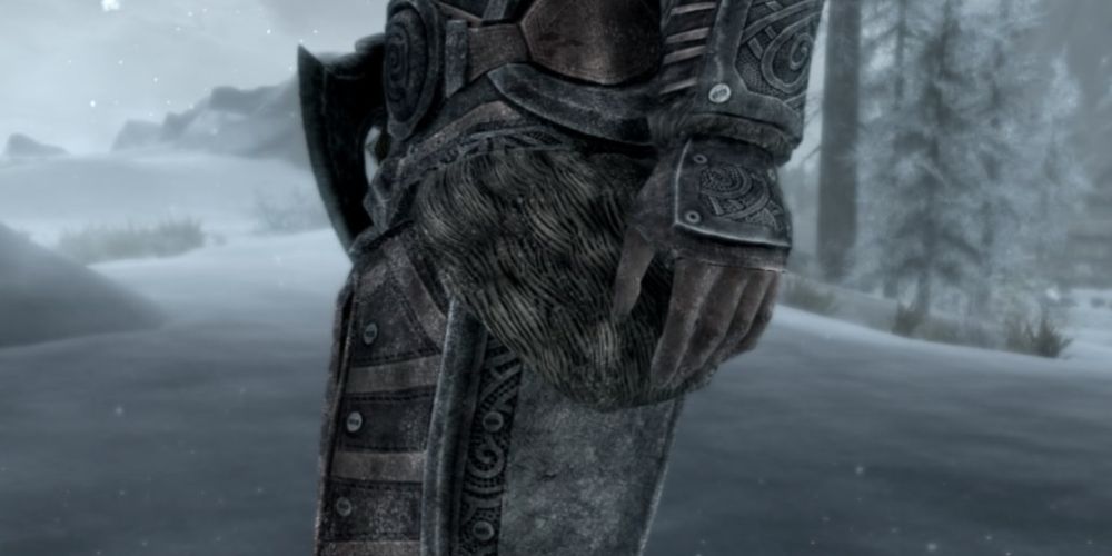 A close-up of a character's armor glazed with snow in a snowy area