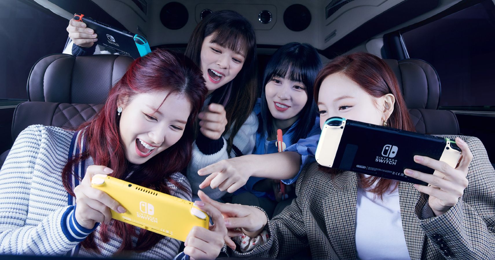 Members of TWICE playing with the Nintendo Switch