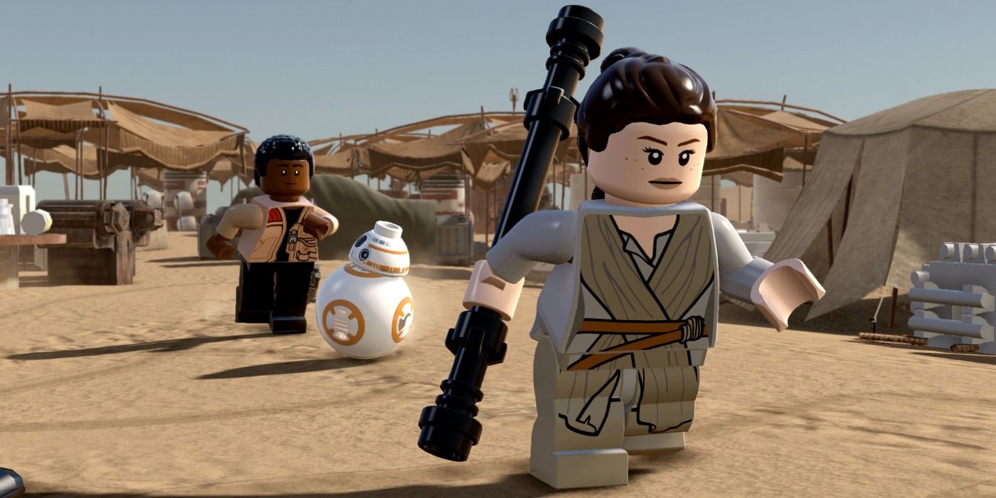 Rey running with a lightsaber with Finn and BB-8 behind during the Jakku chase in Lego Star Wars: The Force Awakens