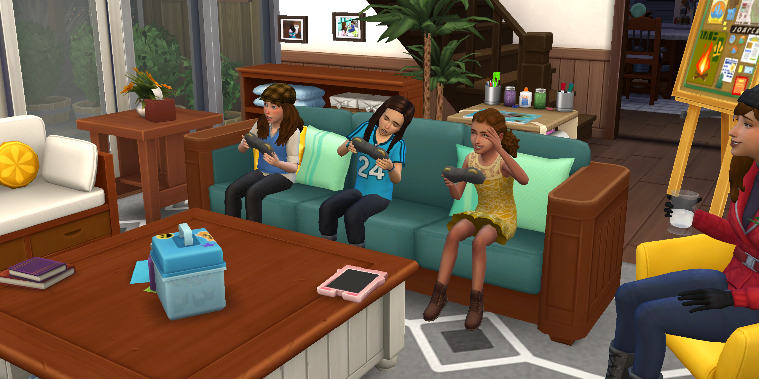 The Sims 4 children sit together and play videogames in the living room