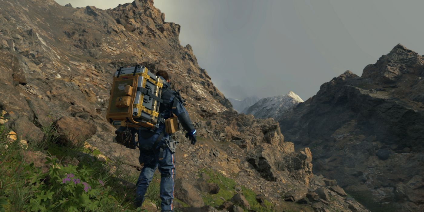 Sam Bridges traverses mountainous terrain in Death Stranding