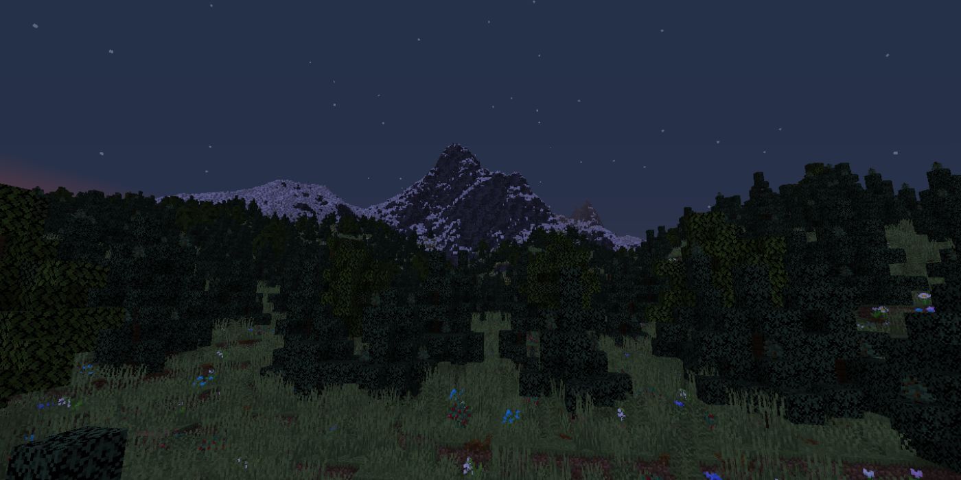 Minecraft mountain over a forest during nighttime