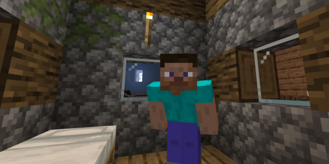 Minecraft player standing next to bed inside house at night
