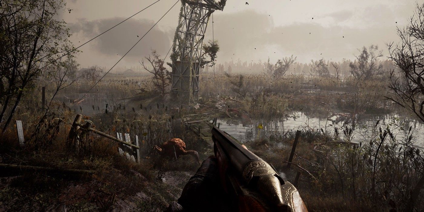 The main player character holding a shotgun near a leaning radio tower and radioactive river with an orange creature crawling about in Stalker 2.