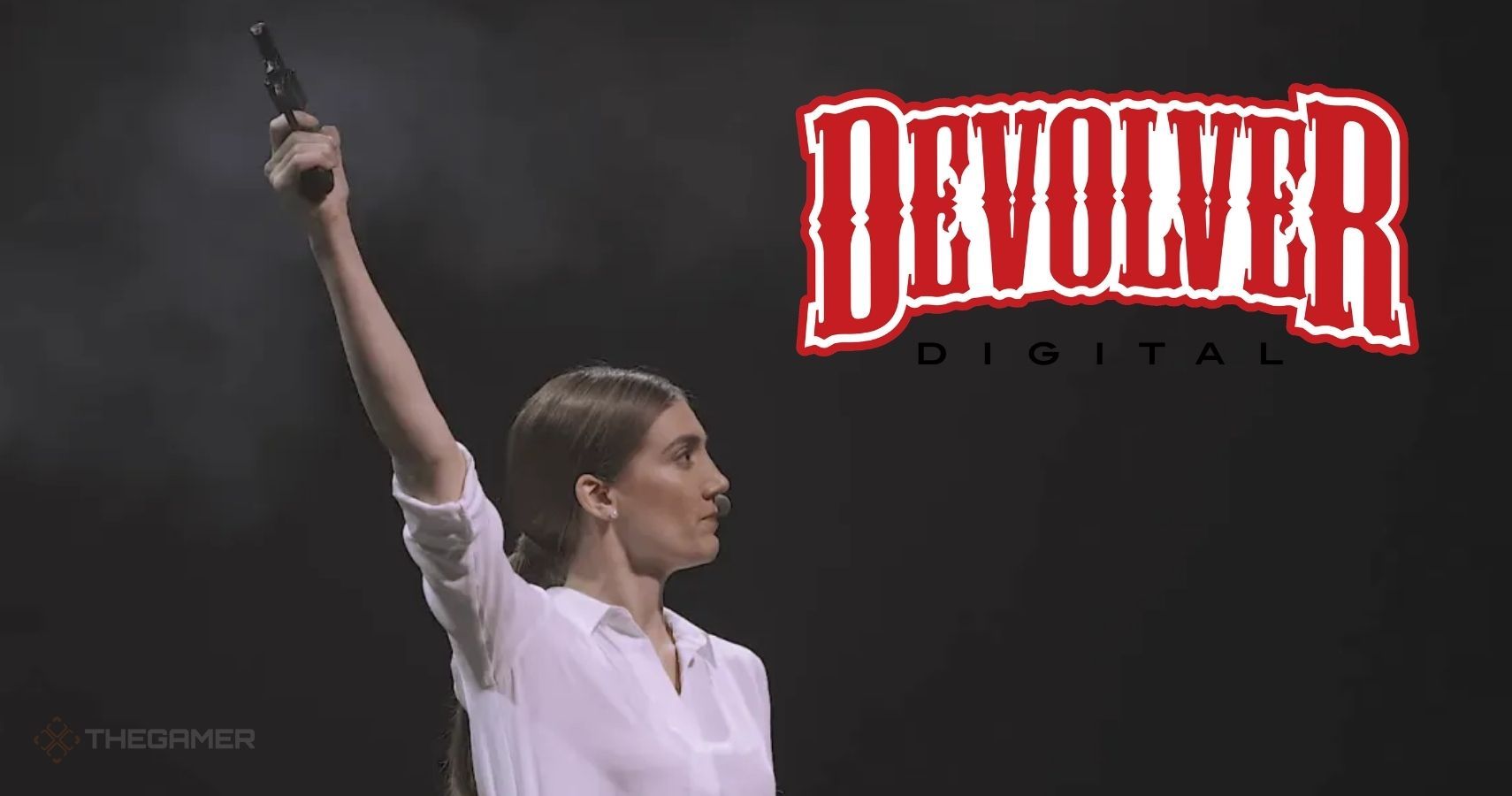 A woman holds a prop gun on stage. The Devolver Digital logo is in the corner,
