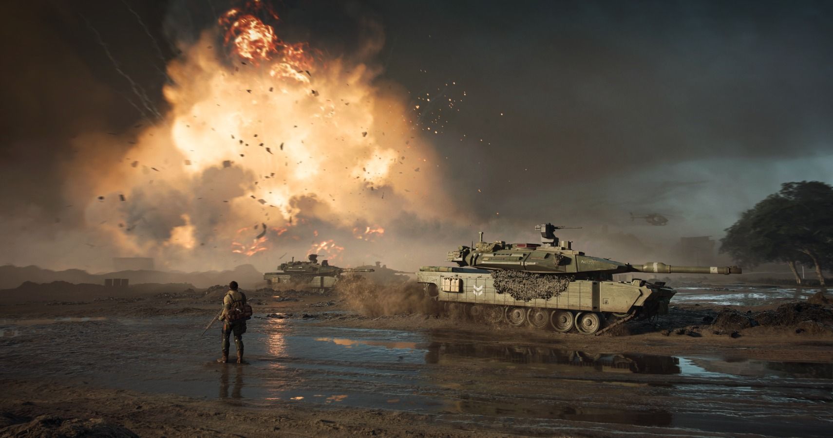 Battlefield 2042 soldier stares at explosion while standing in mud next to a tank