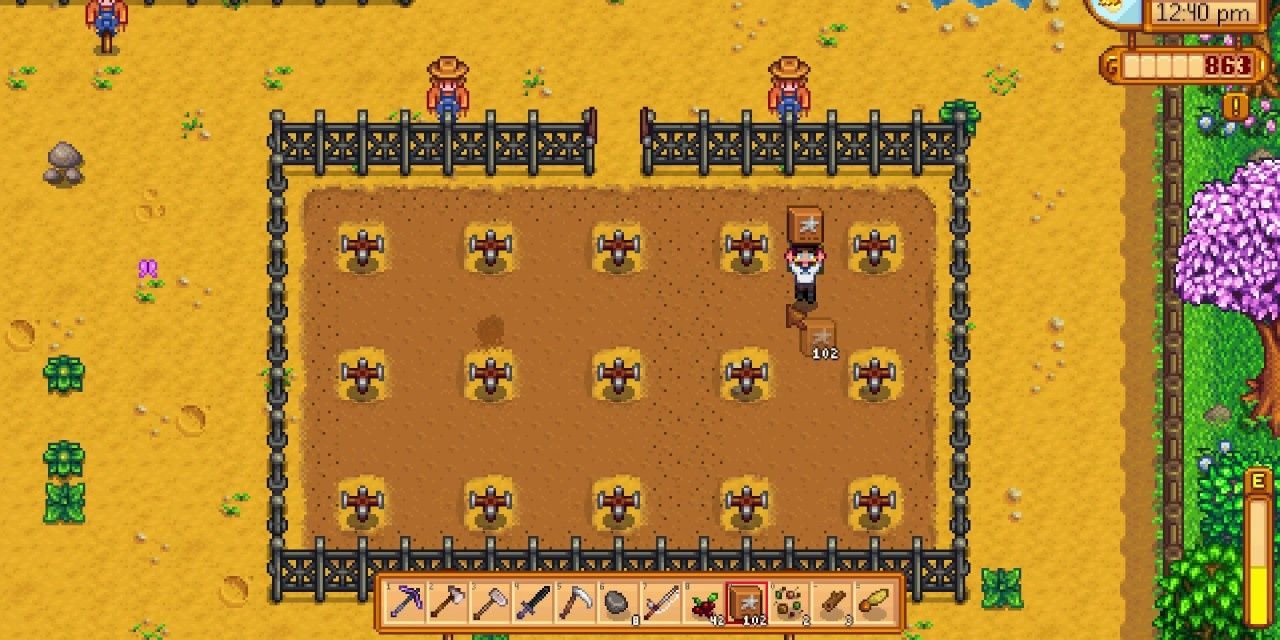 a field of crops with the player spreading basic fertilizer