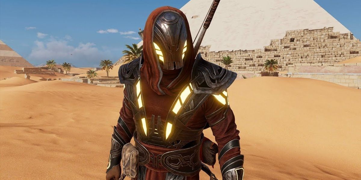 AC Origins a character standing in the Isu Armor surrounded by sand