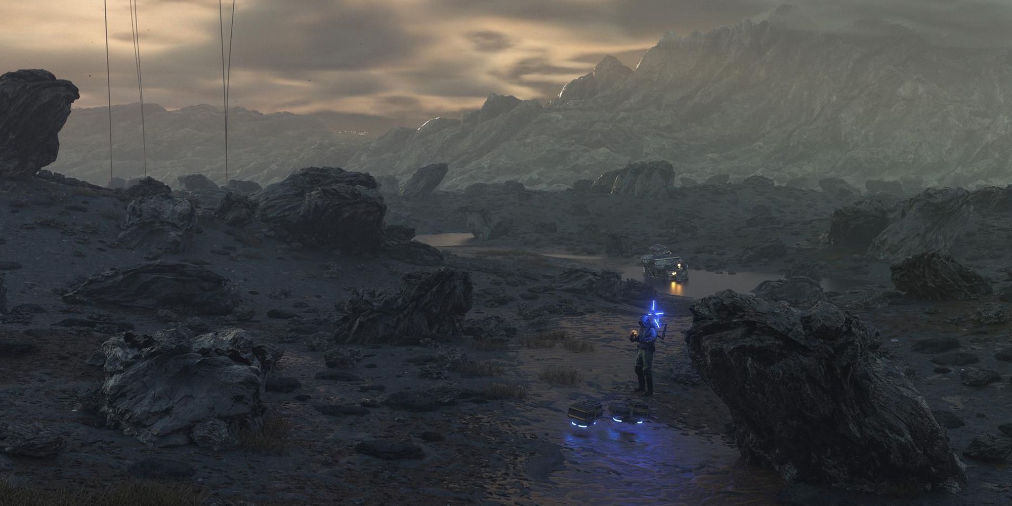 Death Stranding Screenshot Of Sam Porter In The Distance In The Volcanic Rock Area Of The Map