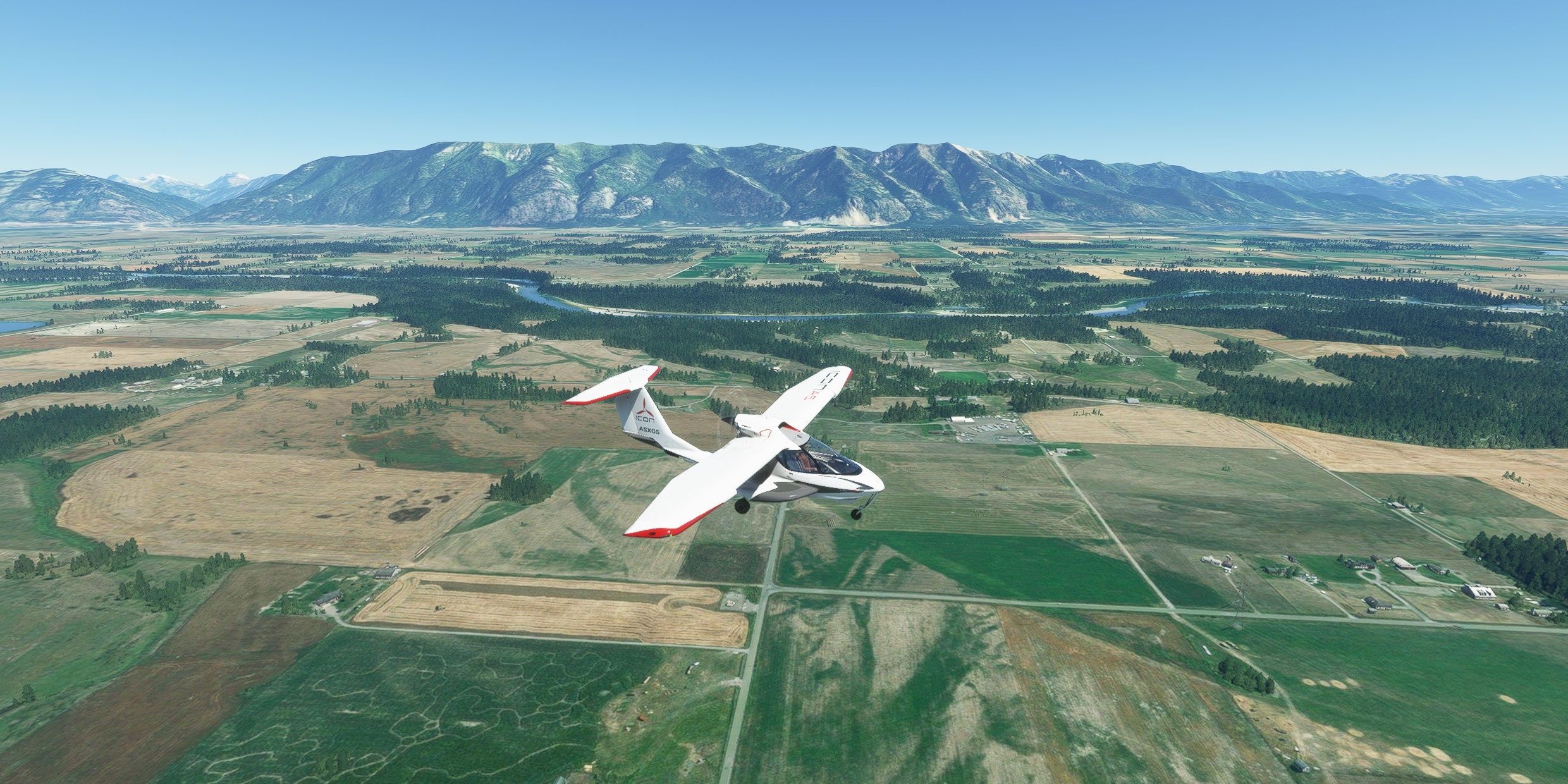 An Icon A5 flying over Glacier Park Montana