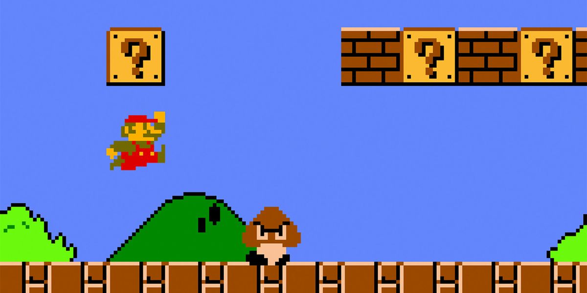 Mario jumping near a Question Mark Block and Goomba in the original Super Mario Bros.