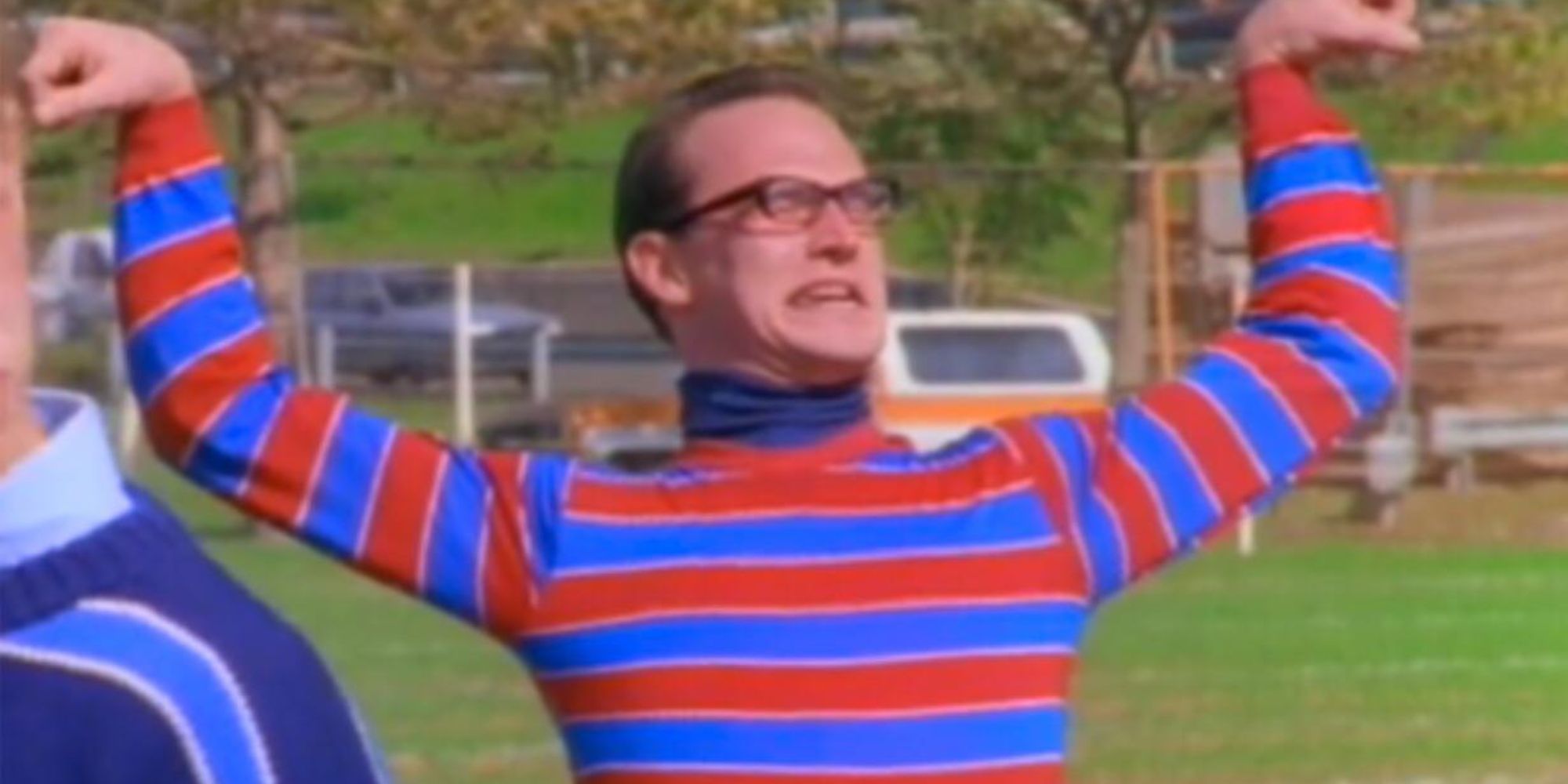 Toby Huss as Artie, the Strongest Man in the World, from Pete and Pete flexing in the middle of a field