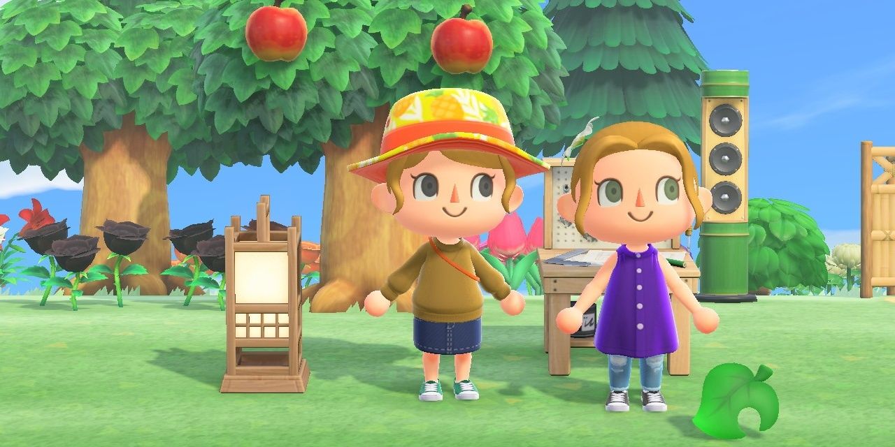 Two Animal Crossing Players on one of their islands in what looks to be the summer. The apple trees and grass are a vibrant green, and the sky is clear and blue