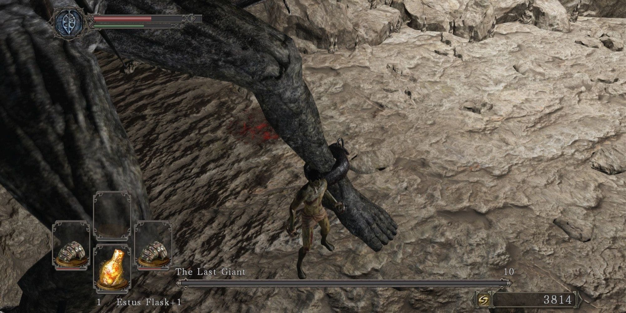 A player beating the Last Giant boss equipped with two caesti. Dark Souls 2