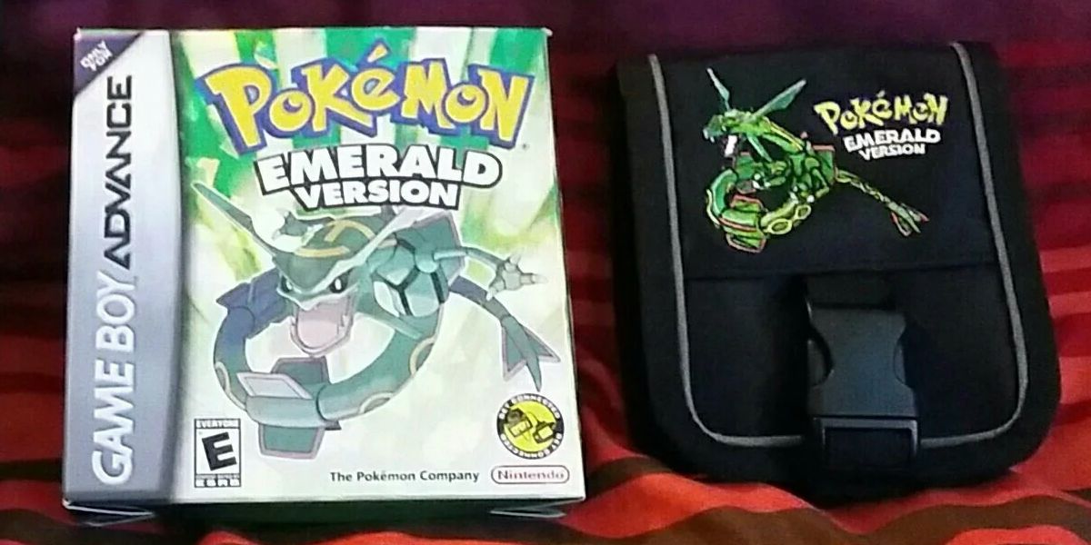Pokemon Emerald In Box And Rayquaza Carrying Case beside it.