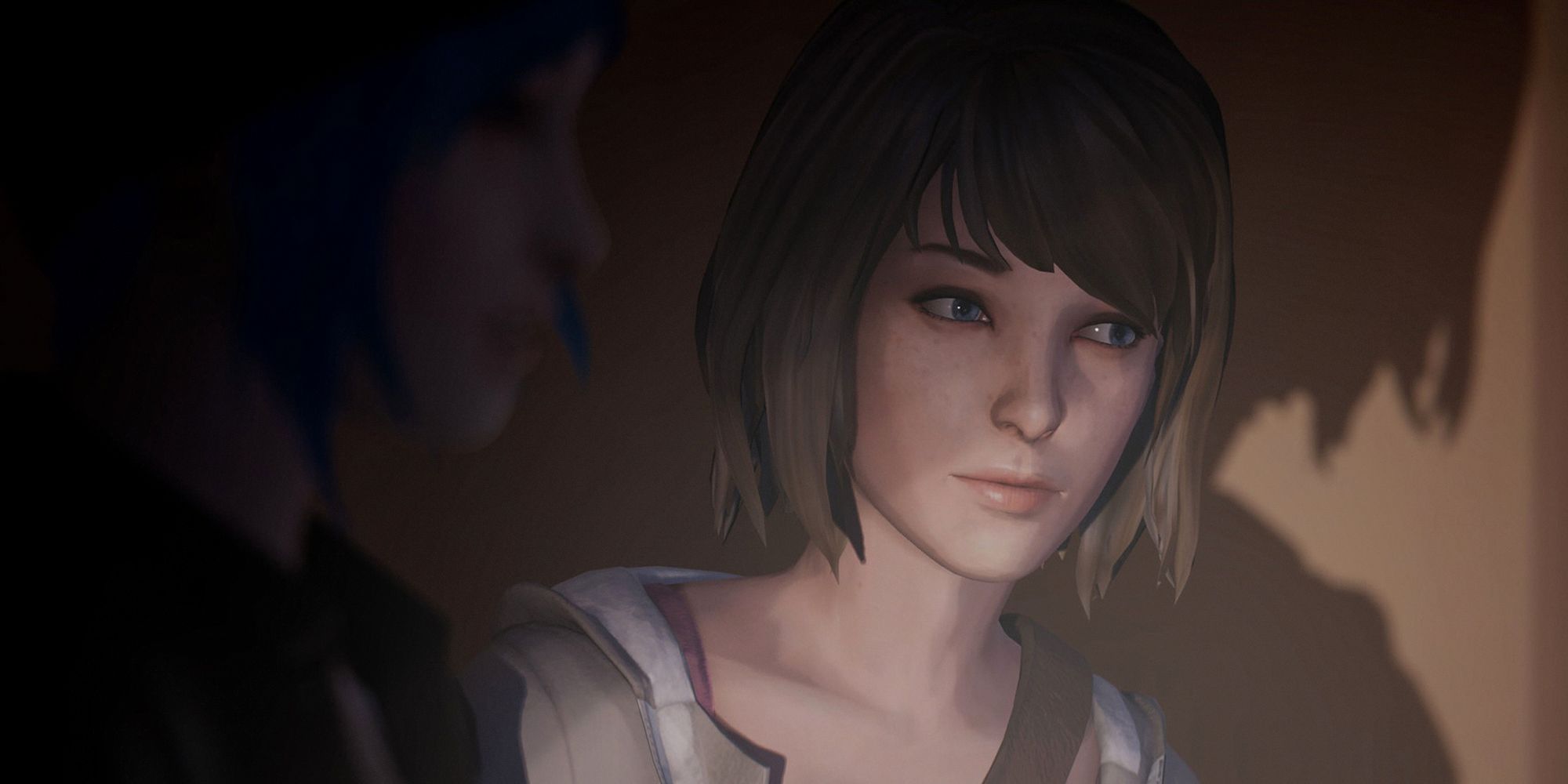 Max Caulfield from Life Is Strange Remastered. She is sitting next to Chloe Price.