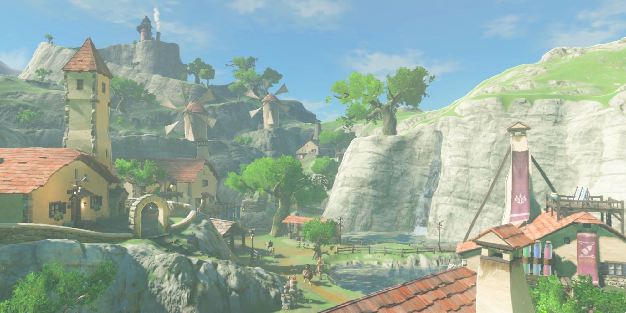 The Legend Of Zelda Locations wide shot of Hateno Village rooftops with people wandering the streets down below and windmills off in the distance