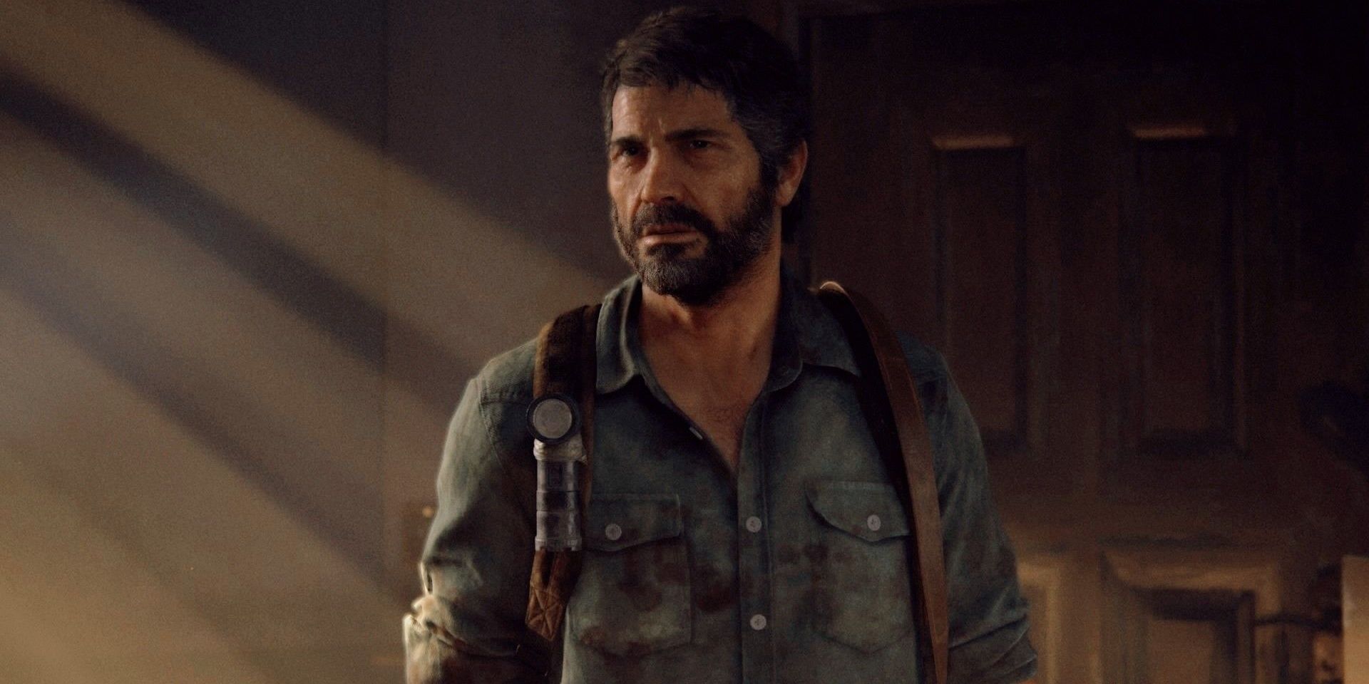 Joel miller in a shadowy room from The Last of Us.