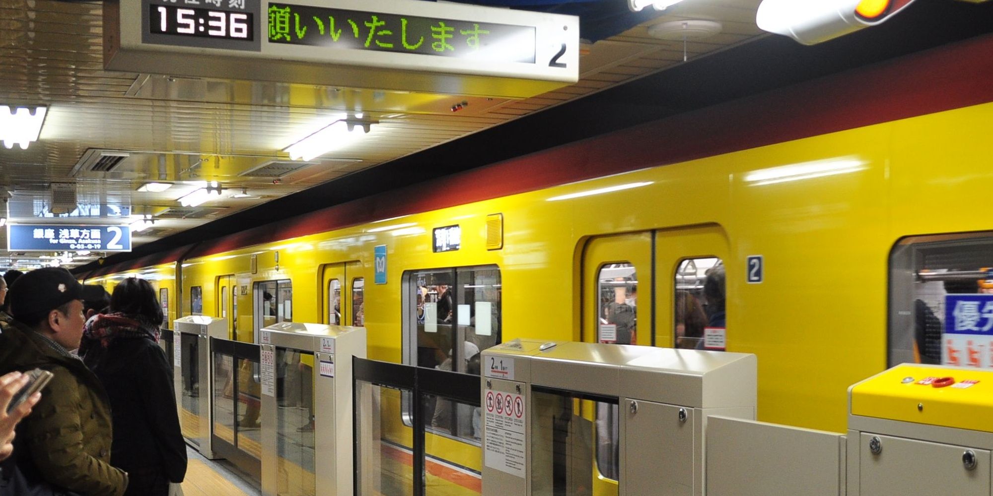 Aoyama-Itchome station platform with yellow train in Japan