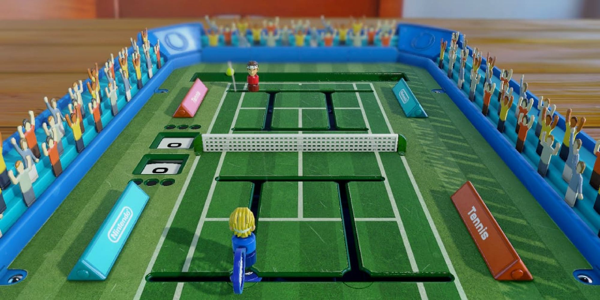 Clubhouse Games a toy set mimicking Tennis with a blue and red player on either side of the net 