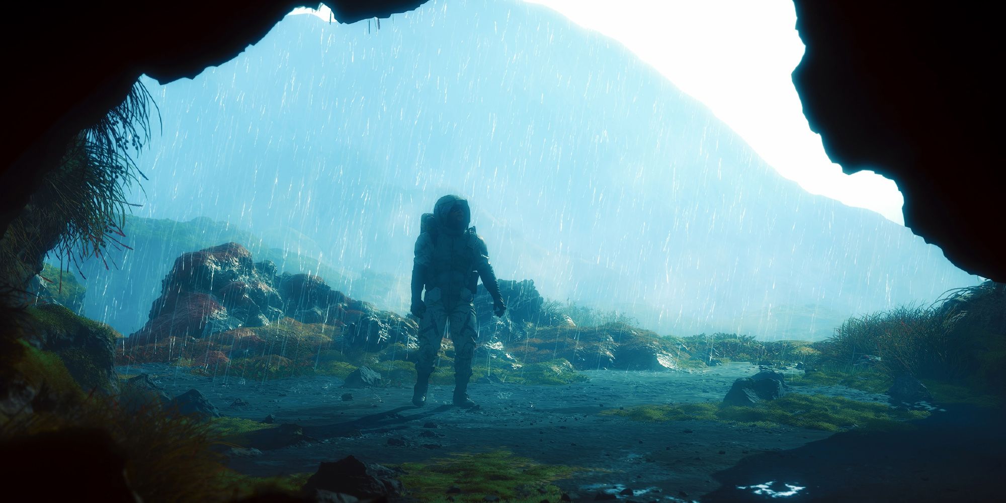 Death Stranding - Sam Standing Outside A Cave In The Timefall