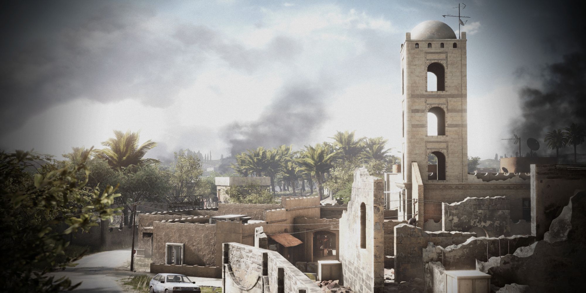 Insurgency Sandstorm Maps a dusky wide shot of the map Farmhouse with ruined buildings and a short tower surrounded by trees in the foreground and a smoke filled sky in the background