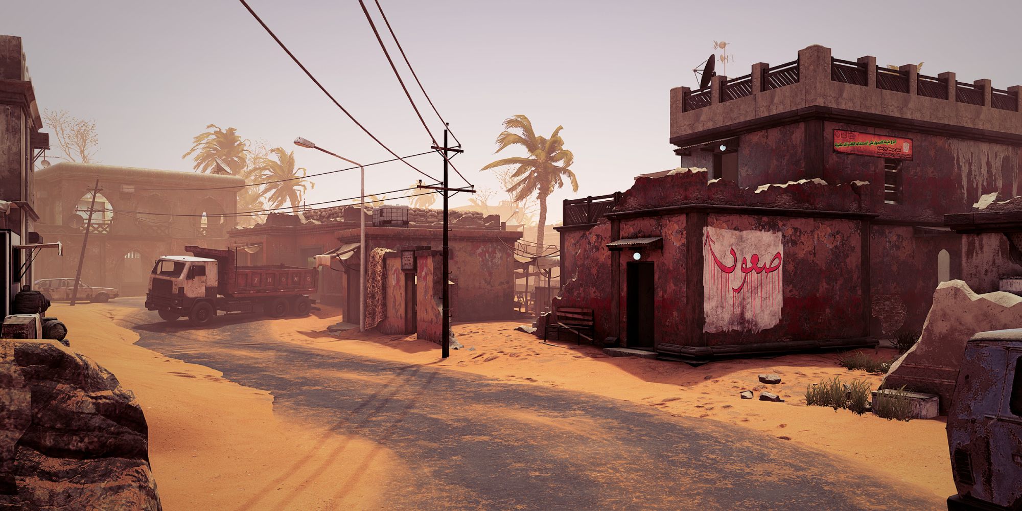 Insurgency Sandstorm Maps a wide shot of the map Tideway with a sand-covered path leading up to dilapidated middle eastern buildings and telephone lines