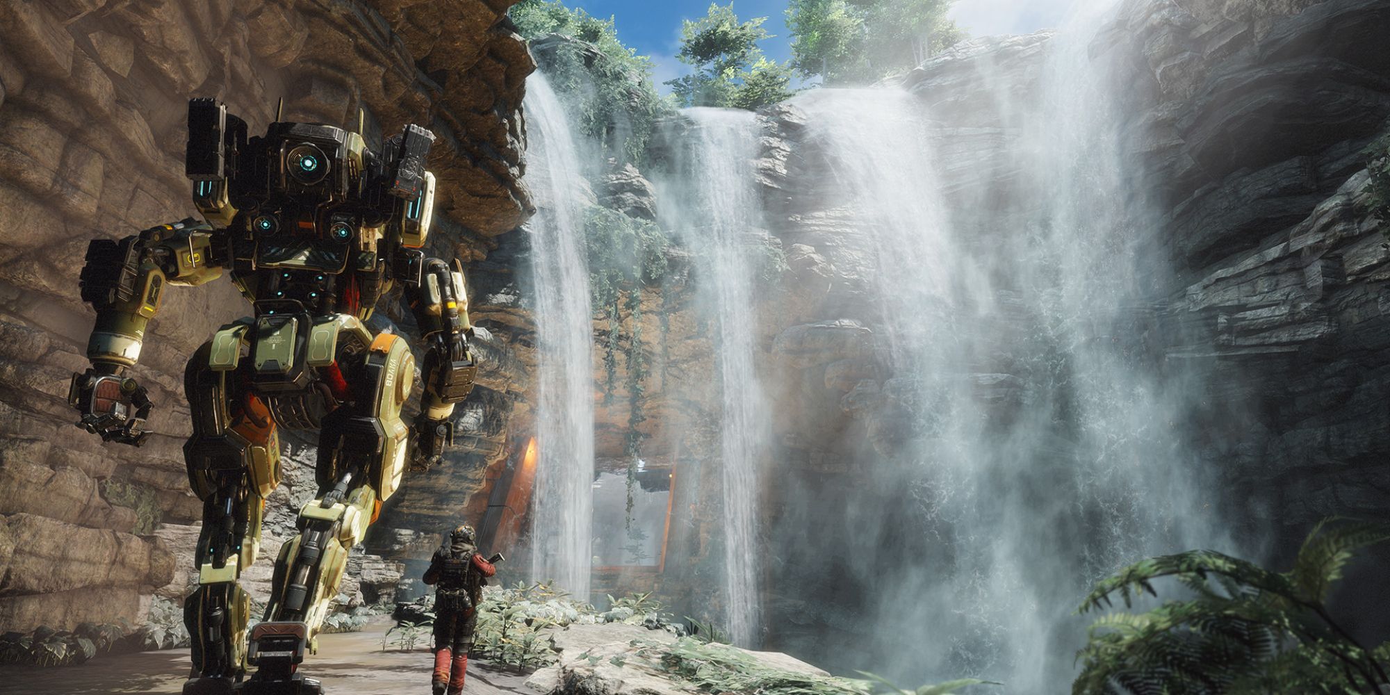 Robots In Video Games a wide shot of the towering green and yellow robot BT next to the protagonist of Titanfall 2 Jack Cooper on the far left walking towards a cascading waterfall on the right