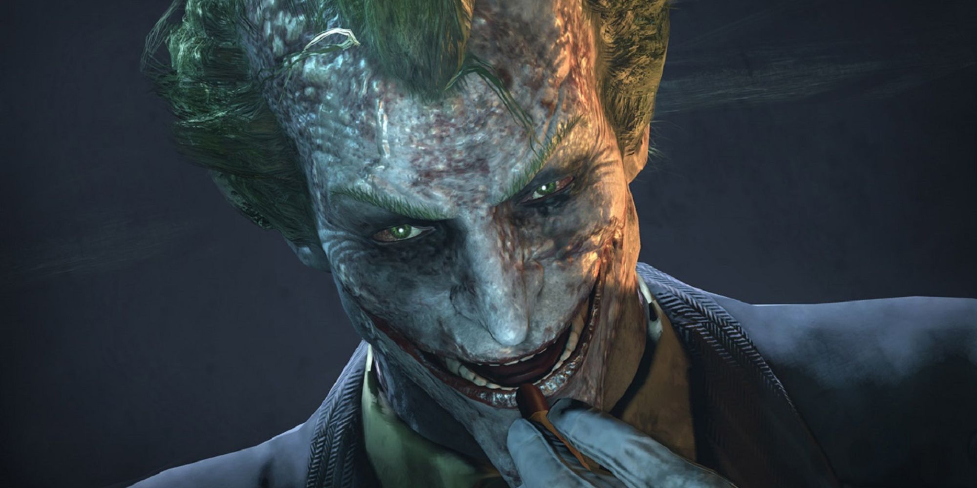 The Joker looks into the camera as he applies lipstick.