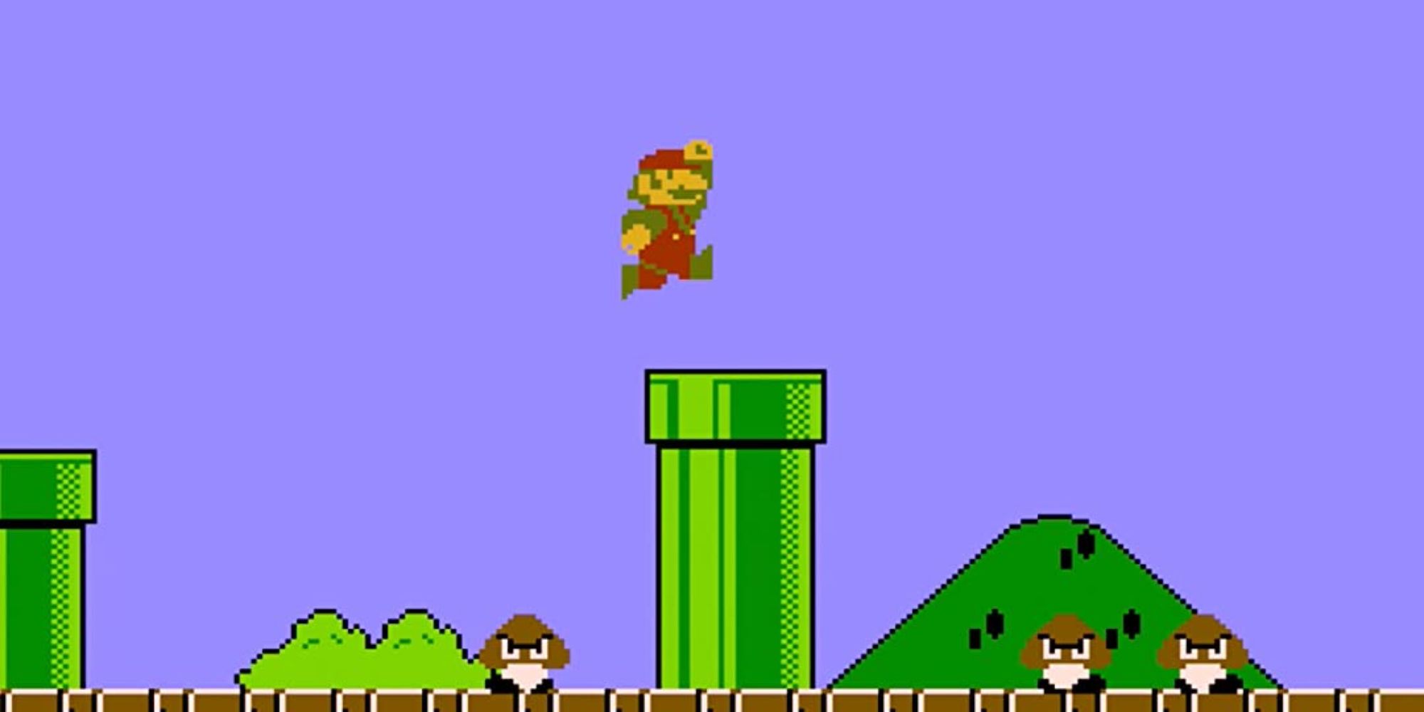 Video Game Sound Effects a wide shot of the classic Mario game with Mario jumping over a green pipe while Goombas roam around beneath him