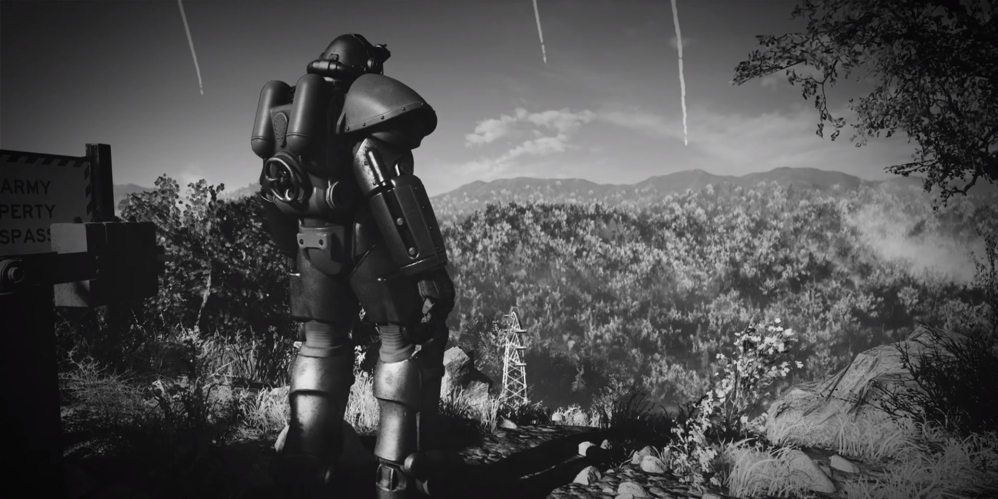 Black and white screenshot from Fallout 76 cinematic with Power Armor character standing on a hill with bombs dropping in the background