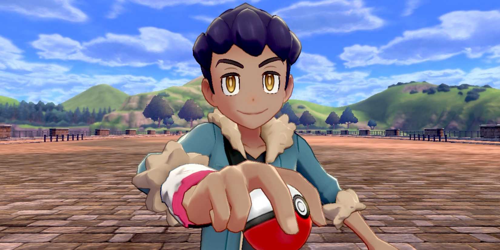 Hop holding a Poke Ball and smiling at the camera in Pokemon Sword and Shield.