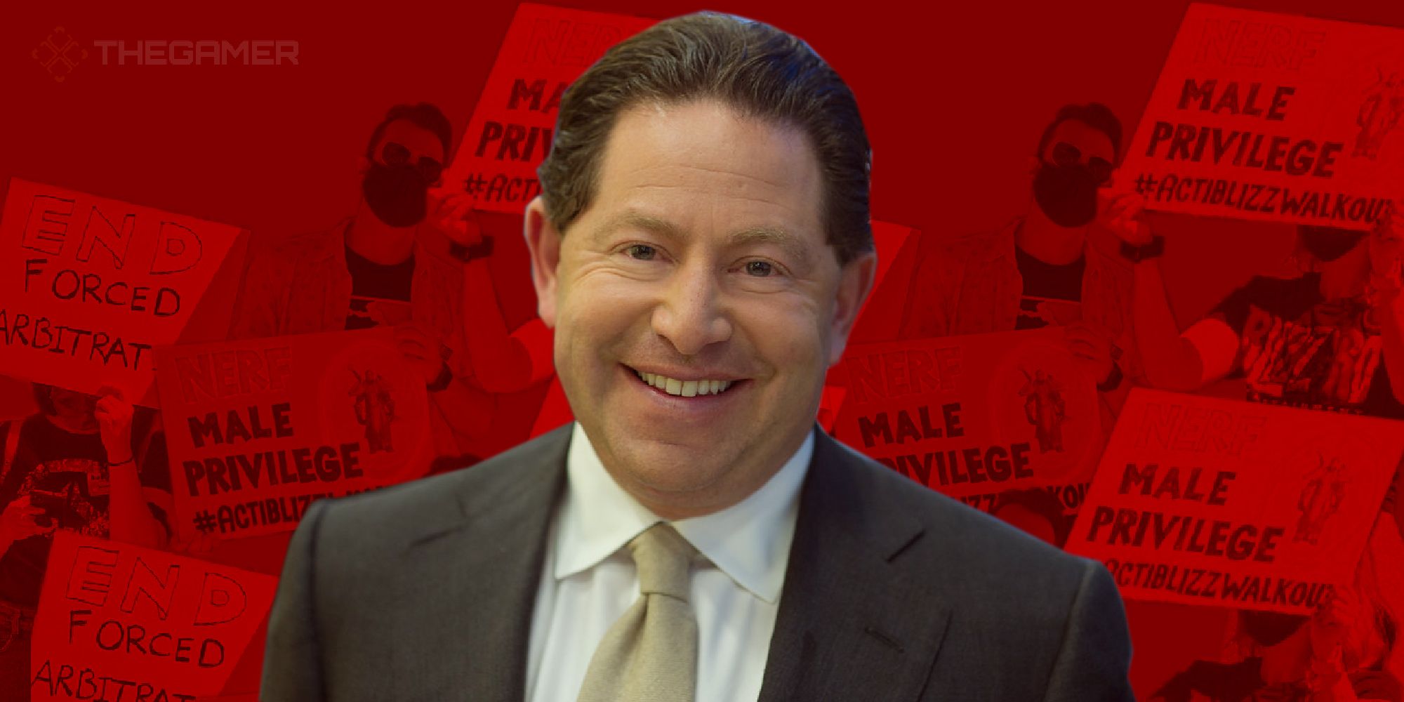 activision blizzard ceo bobby kotick in front of signs that say male privilige