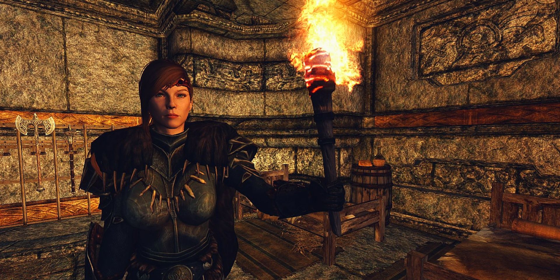 A player holding a torch in Skyrim
